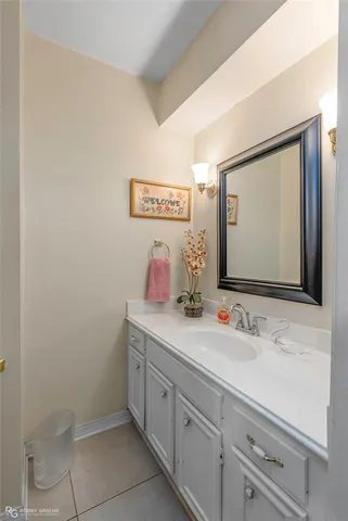 a bathroom with a sink mirror and vanity