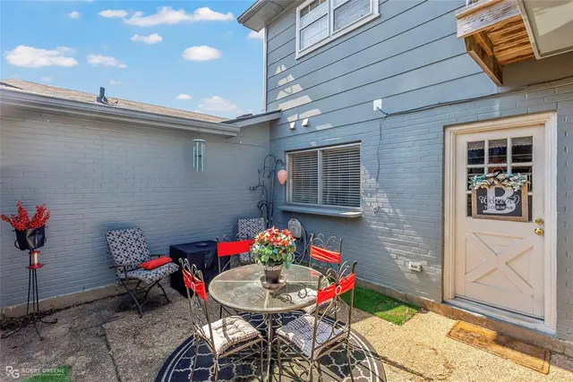 a backyard of a house with table and chairs