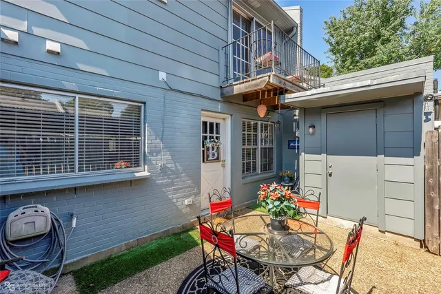a outdoor space with a table and chairs