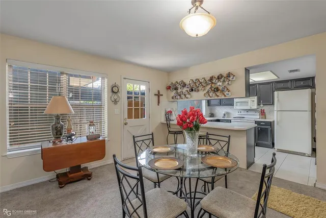 a dining room with furniture and window
