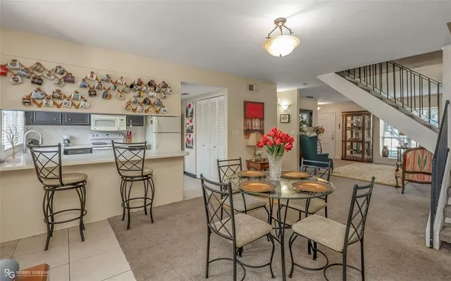 a view of a dining room with furniture and a chandelier