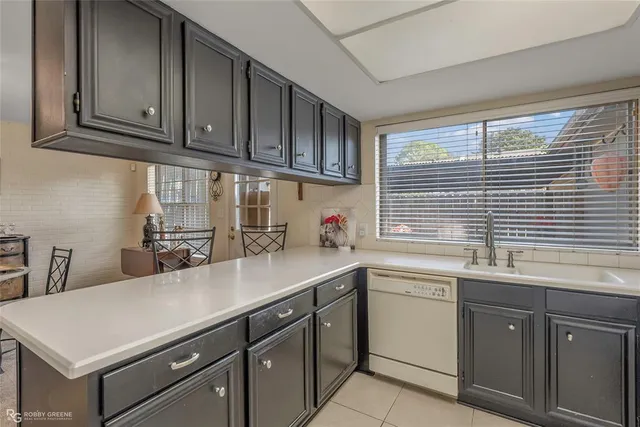 a kitchen with stainless steel appliances a sink a stove and cabinets