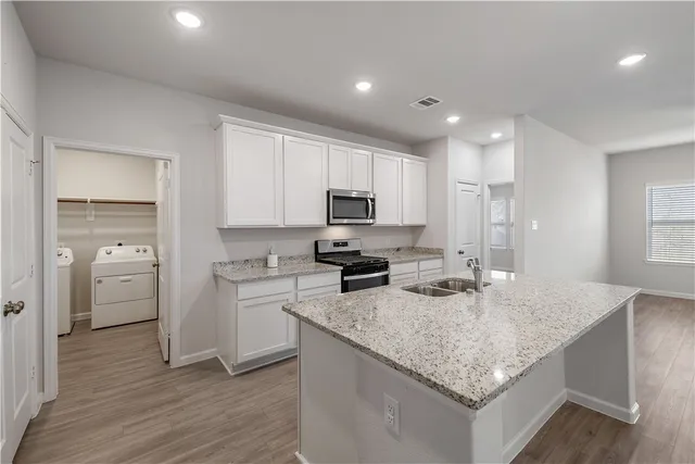 a kitchen with a sink stove and refrigerator