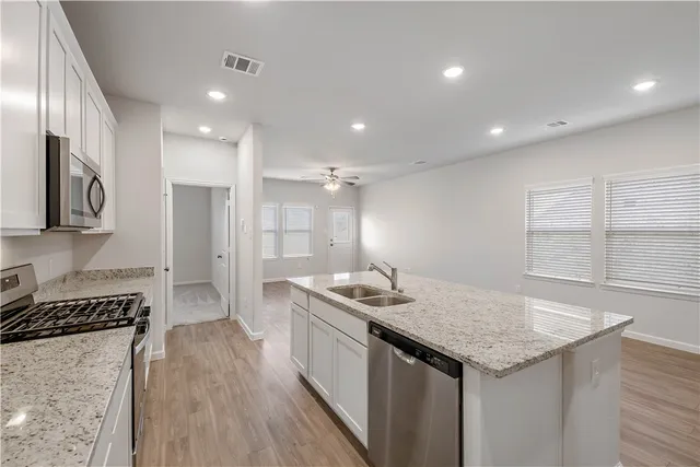 a kitchen with a sink stove and refrigerator