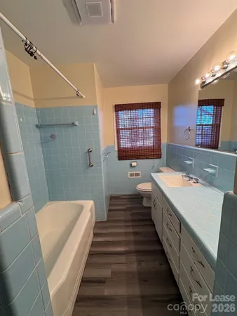 a bathroom with a sink a large mirror and a bathtub