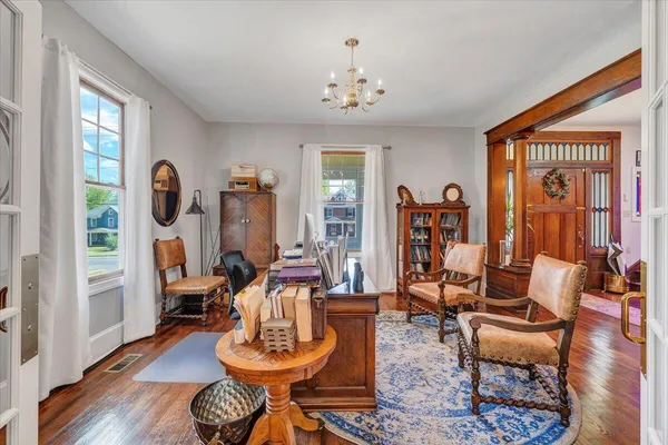 a living room with furniture and a chandelier