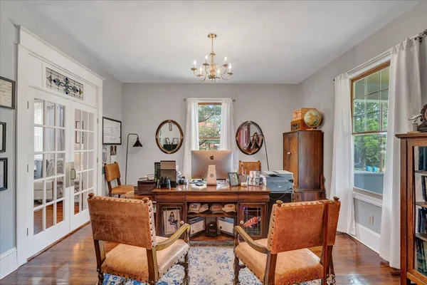 a living room with furniture and a chandelier