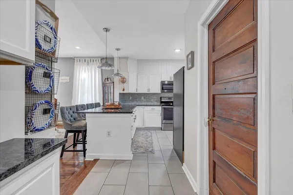 a kitchen with stainless steel appliances granite countertop a refrigerator and a sink