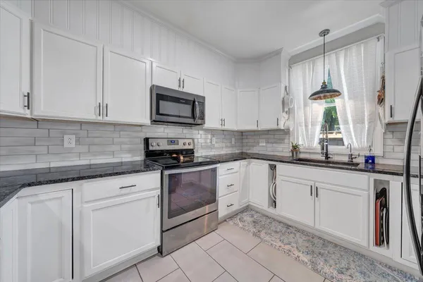 a kitchen with counter top space cabinets and stainless steel appliances