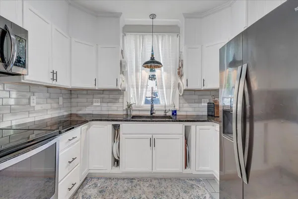 a kitchen with stainless steel appliances a refrigerator and cabinets