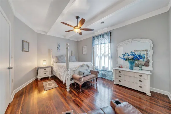 a bedroom with a bed and wooden floor