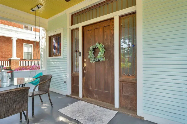 a view of an entryway with wooden floor and windows