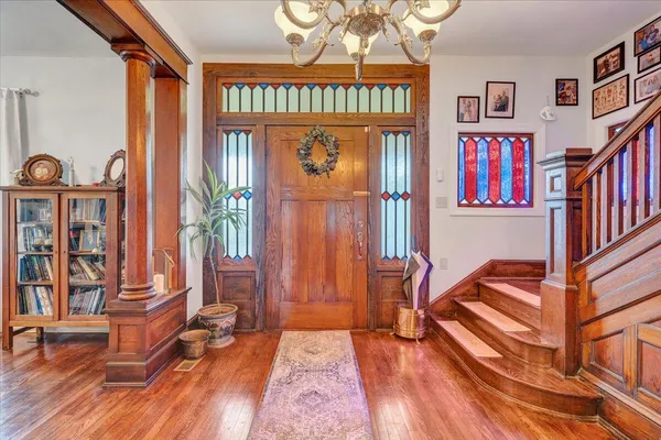 a view of a livingroom with furniture wooden floor windows and a chandelier