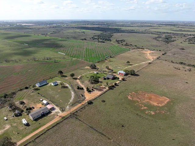 an aerial view of a house with a lake view
