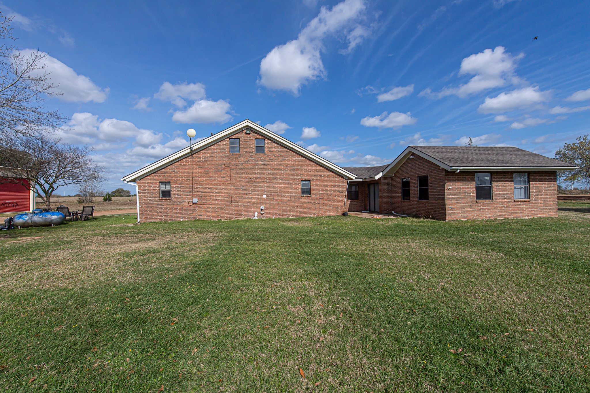 1195 Sens Road Sealy, TX 77474 - Photo 11 of 50 a front view of a house with a garden and yard