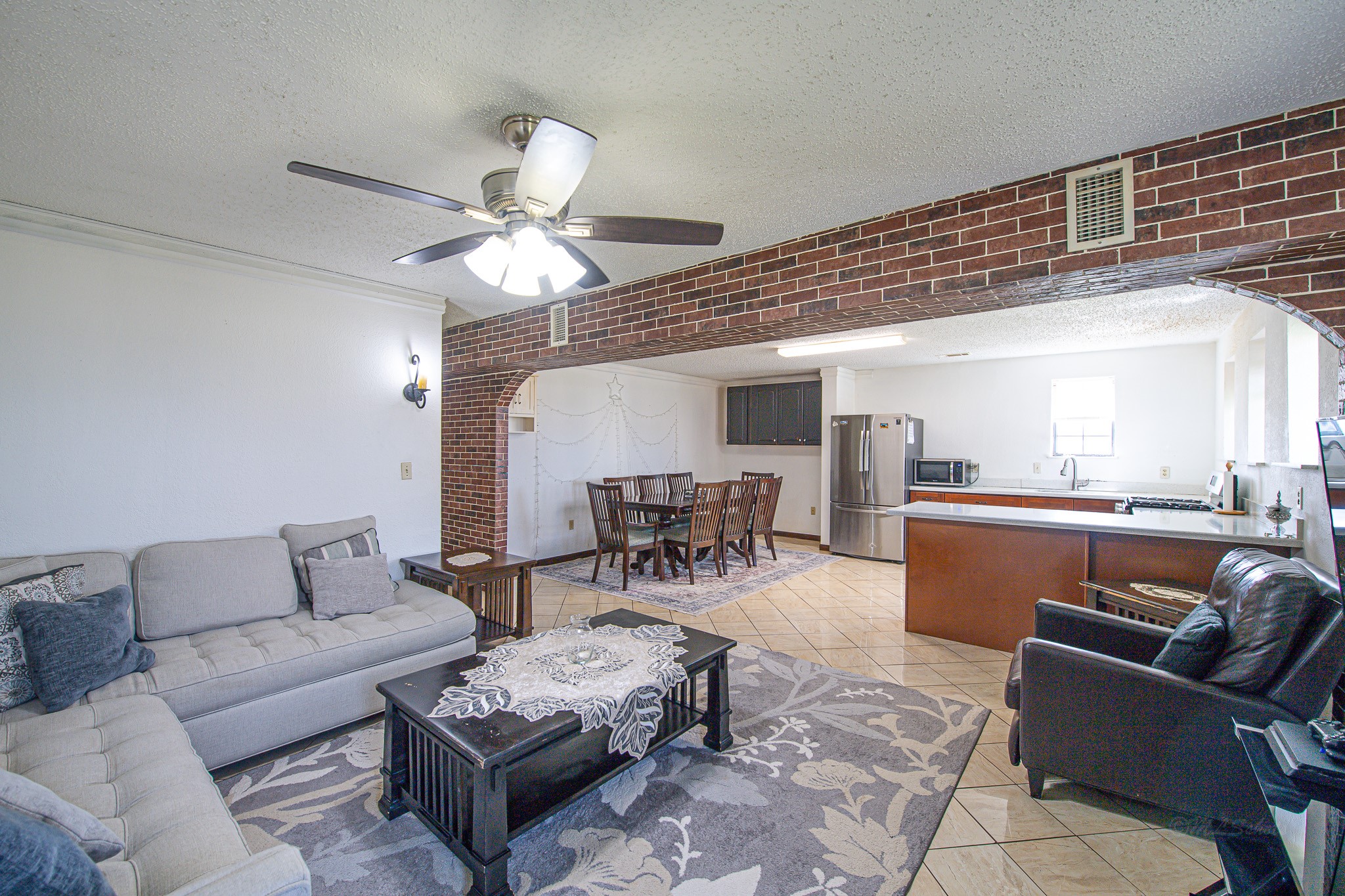 1195 Sens Road Sealy, TX 77474 - Photo 18 of 50 a living room with furniture a fireplace and a chandelier