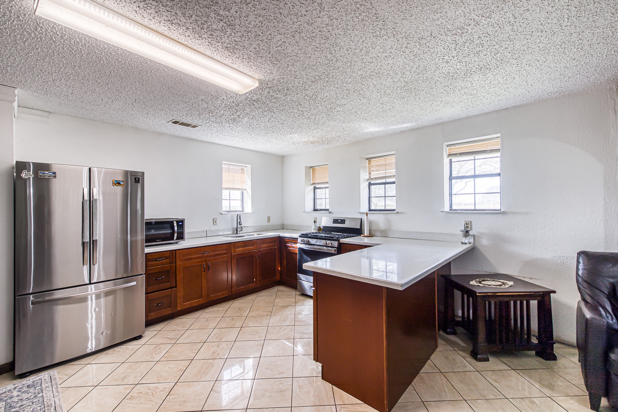 1195 Sens Road Sealy, TX 77474 - Photo 21 of 50 a kitchen with stainless steel appliances granite countertop a sink stove and refrigerator