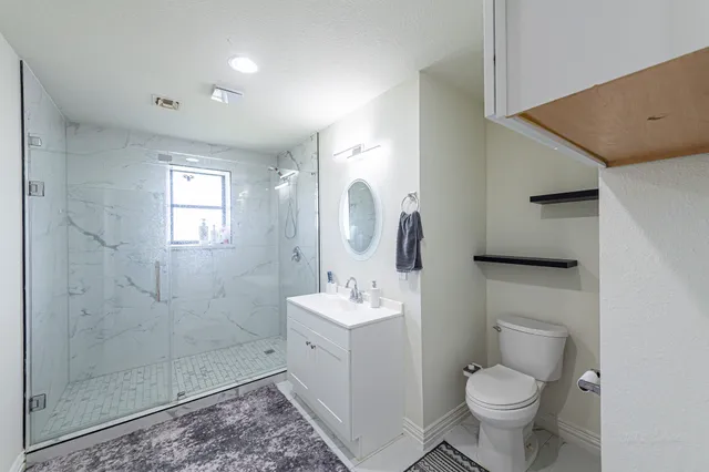 a bathroom with a sink vanity and toilet