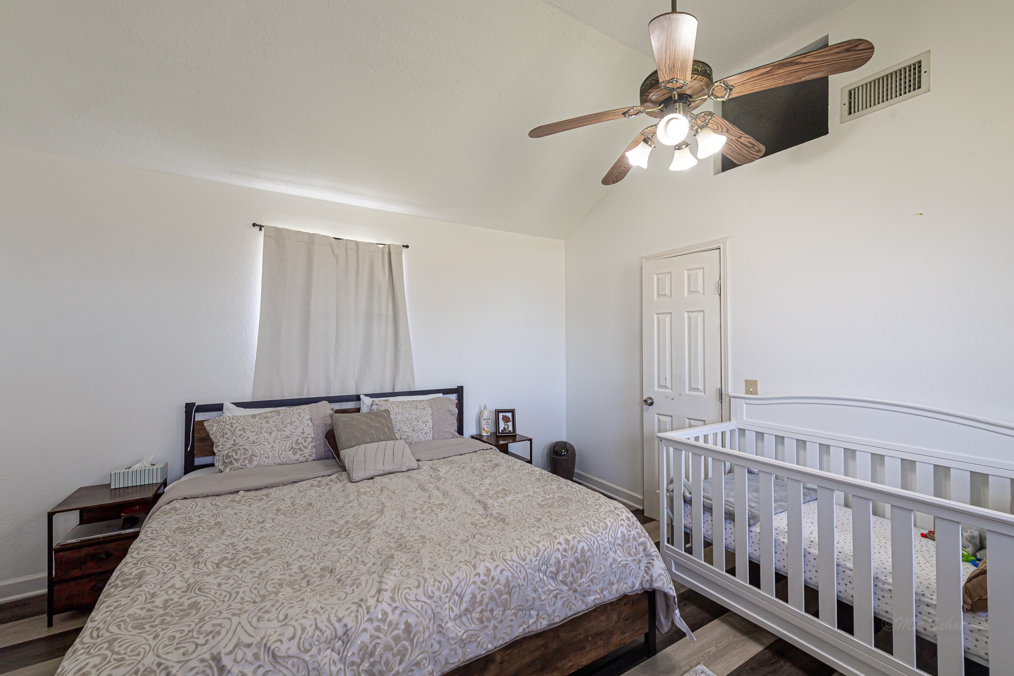 1195 Sens Road Sealy, TX 77474 - Photo 33 of 50 a bedroom with a bed and a chandelier