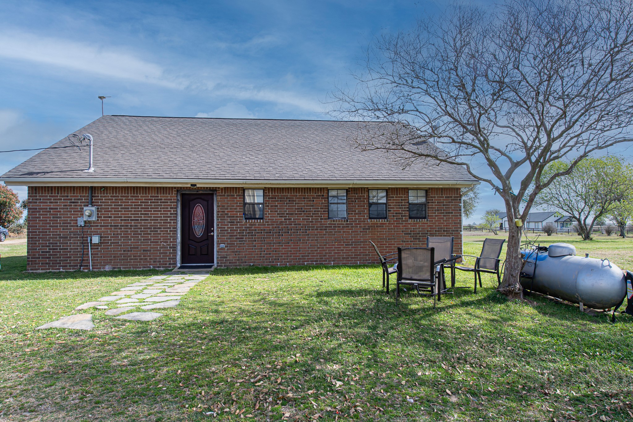 1195 Sens Road Sealy, TX 77474 - Photo 9 of 50 a backyard of a house with table and chairs