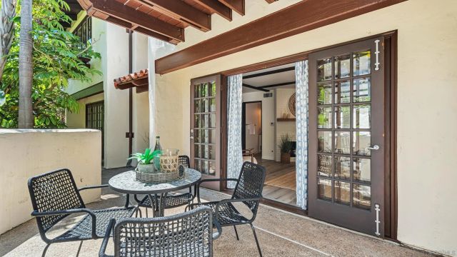 a backyard of a house with table and chairs