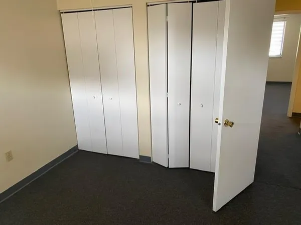 an empty room with closet area