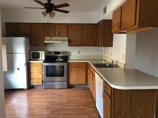 a kitchen with a sink a stove and refrigerator