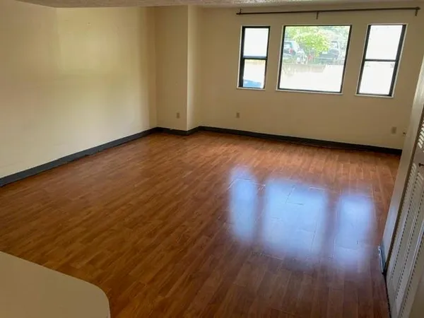 a view of an empty room and wooden floor