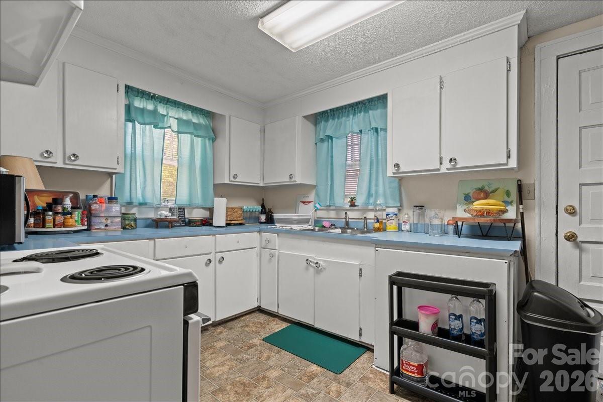 501 Church Street Cheraw, SC 29520 - Photo 39 of 48 a kitchen with cabinets and a stove top oven