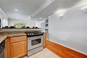 3009 Speedway, Unit 3 Austin, TX 78705 - Photo 9 of 21 a kitchen with granite countertop cabinets stainless steel appliances and wooden floor