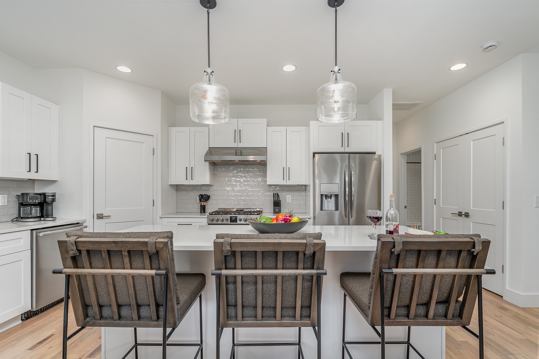 1699 Lischey Avenue Nashville, TN 37207 - Photo 15 of 45 a kitchen with stainless steel appliances kitchen island granite countertop a dining table chairs and white cabinets