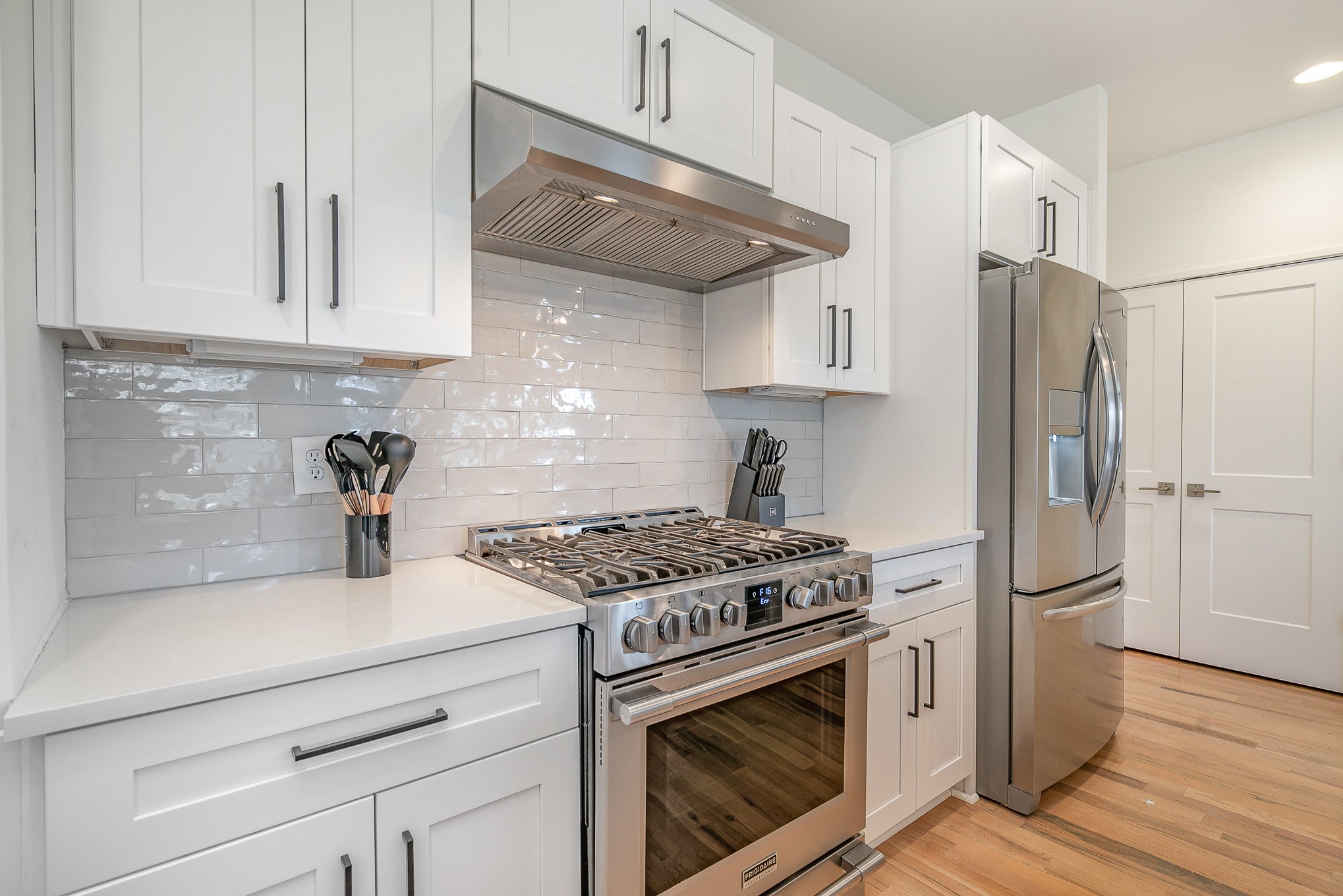 1699 Lischey Avenue Nashville, TN 37207 - Photo 17 of 45 a kitchen with stainless steel appliances granite countertop a stove a refrigerator and a white cabinets