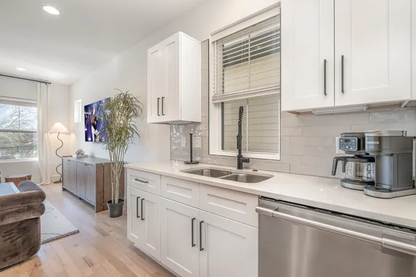 a view of a kitchen counter space and wooden floor