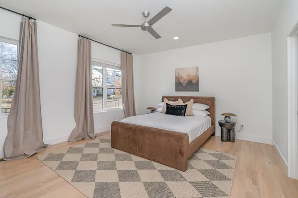 a bedroom with a large bed and a window