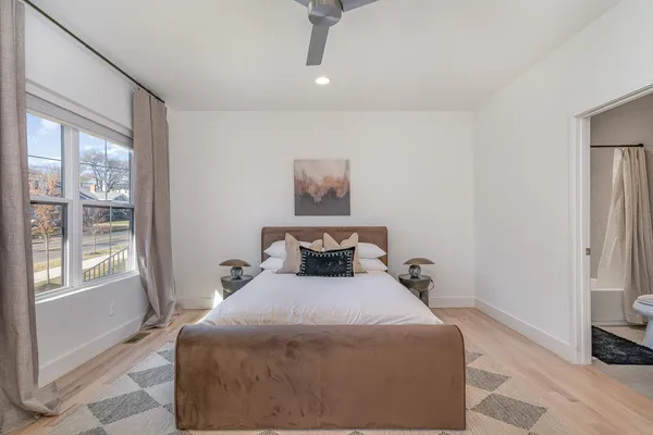 a bedroom with a bed and a mirror