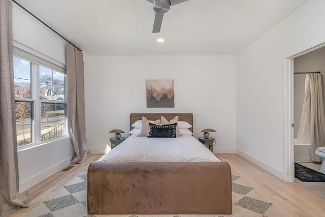 a bedroom with a bed and a mirror