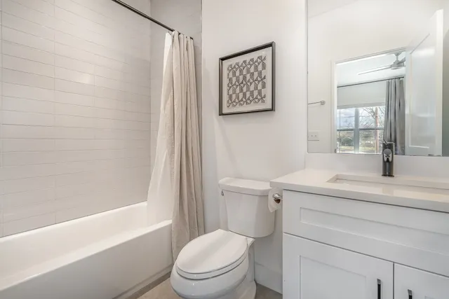 a bedroom with a bed and closet with mirror