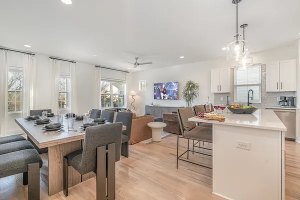 a large kitchen with a table and chairs