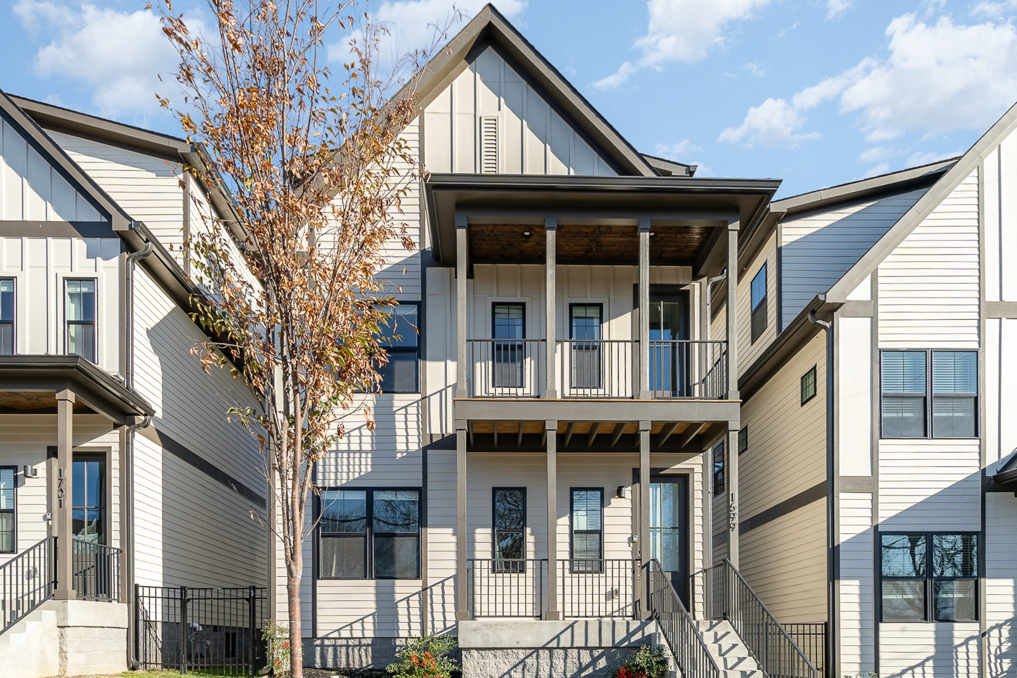 1699 Lischey Avenue Nashville, TN 37207 - Photo 6 of 45 a view of small white house with large windows and a tree