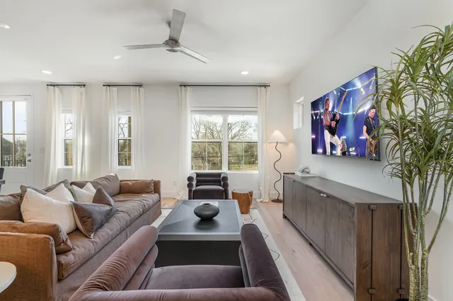 a living room with furniture kitchen view and a table