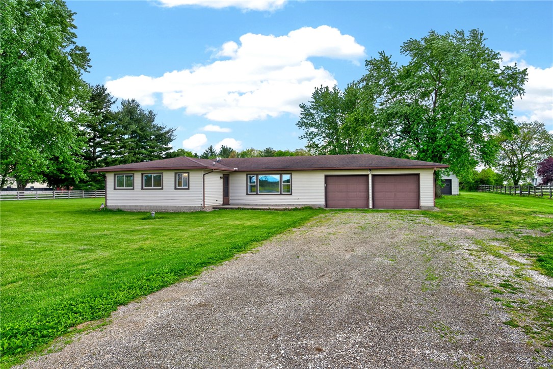 1005 Free Road New Carlisle, OH 45344 - Photo 2 of 43 A charming ranch home with an expansive lawn, ideal for peaceful country living.