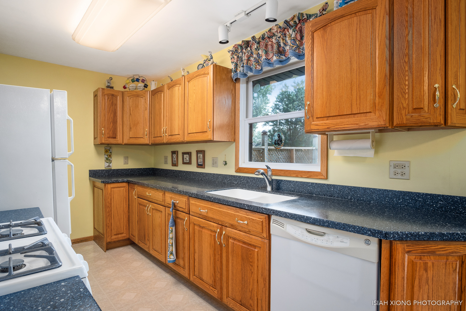 91 Neil Road Sugar Grove, IL 60554 - Photo 11 of 31 a kitchen with granite countertop a sink stainless steel appliances and cabinets