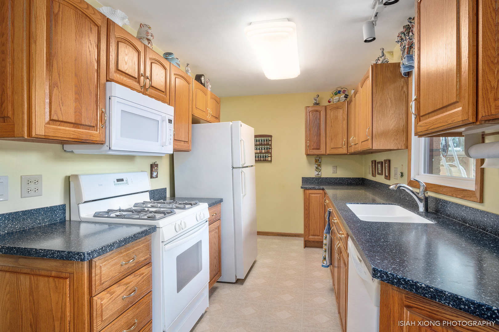 91 Neil Road Sugar Grove, IL 60554 - Photo 10 of 31 a kitchen with stainless steel appliances granite countertop a sink a stove and a refrigerator