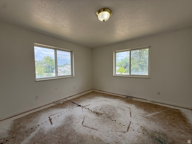 838 East Mountain Road Logan, UT 84321 - Photo 22 of 37 Room featuring two windows, a ceiling-mounted light fixture, and baseboard trim
