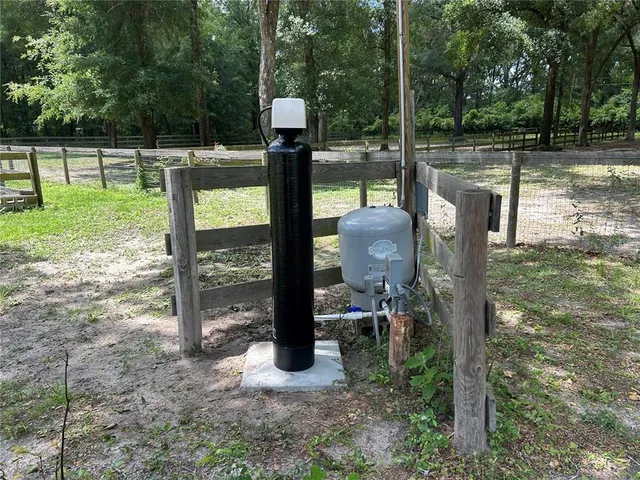 a view of a patio with a table chairs and a backyard