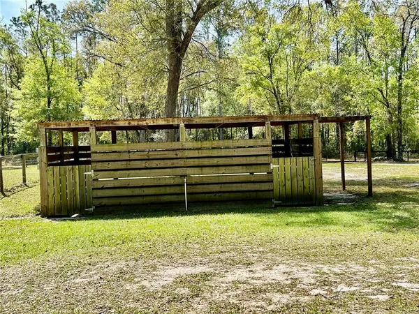 a view of outdoor space with deck and a lake view