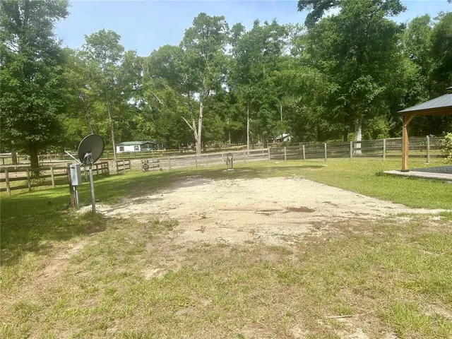 a view of swimming pool with a yard and trees