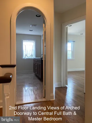 hallway view with wooden floor and windows