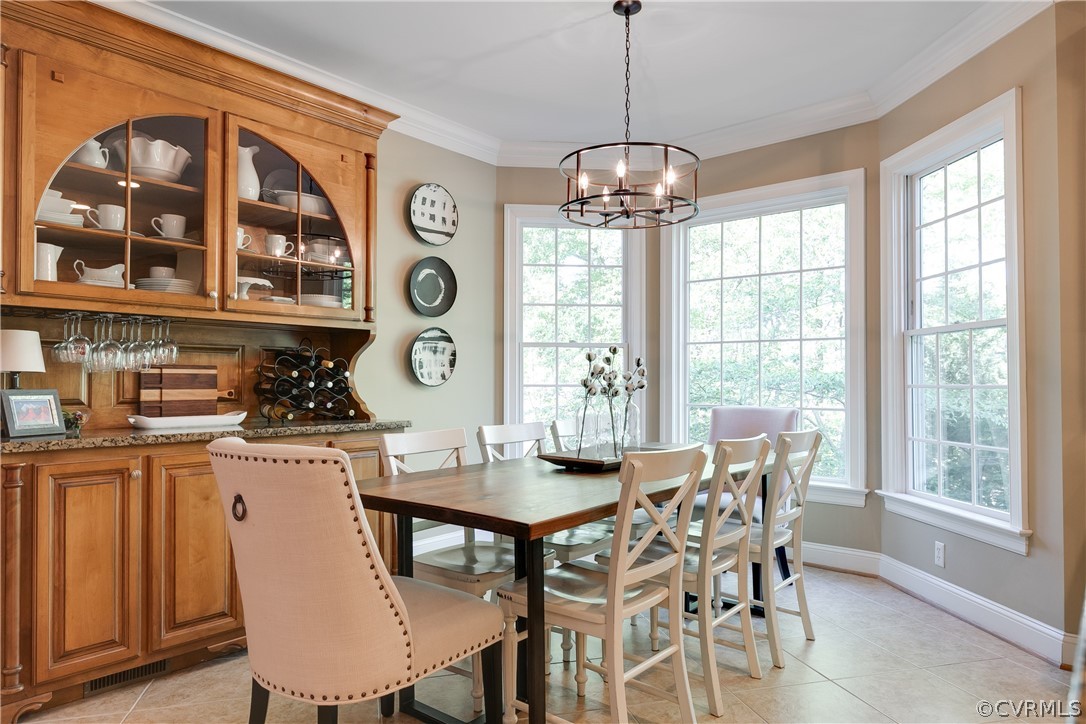14641 West Salisbury Road Midlothian, VA 23113 - Photo 15 of 50 a dining room with wooden floor a chandelier a wooden table and chairs