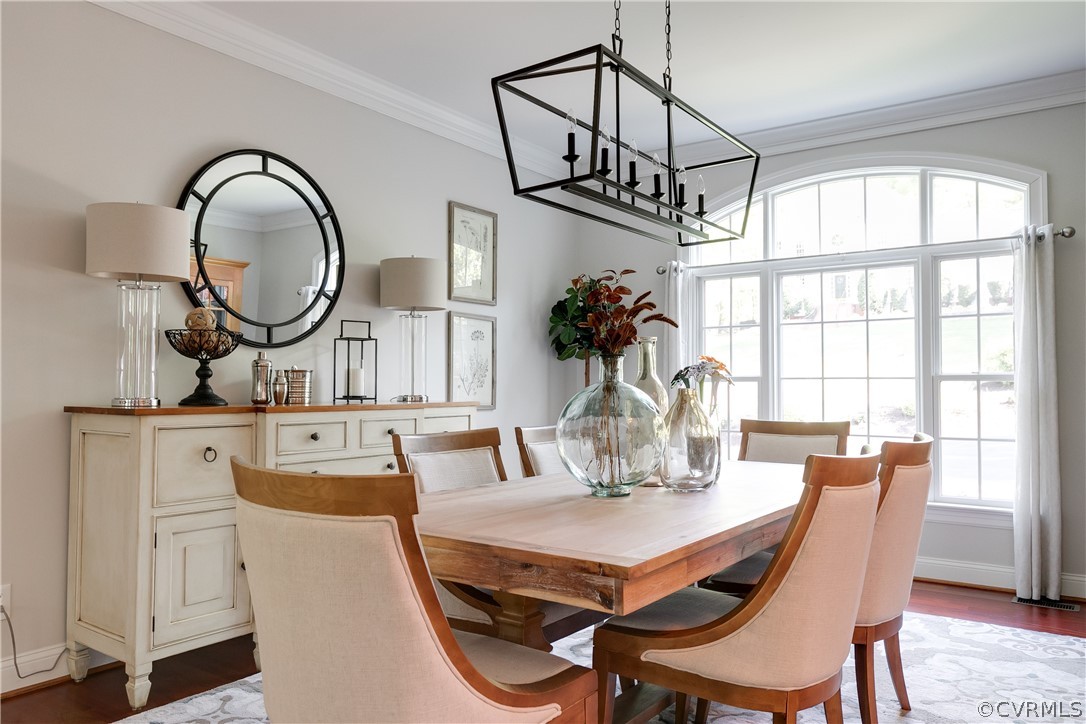 14641 West Salisbury Road Midlothian, VA 23113 - Photo 16 of 50 a dining room with furniture a chandelier and wooden floor
